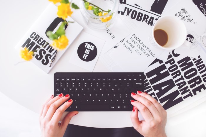 kaboompics-girl-writing-on-a-black-keyboard