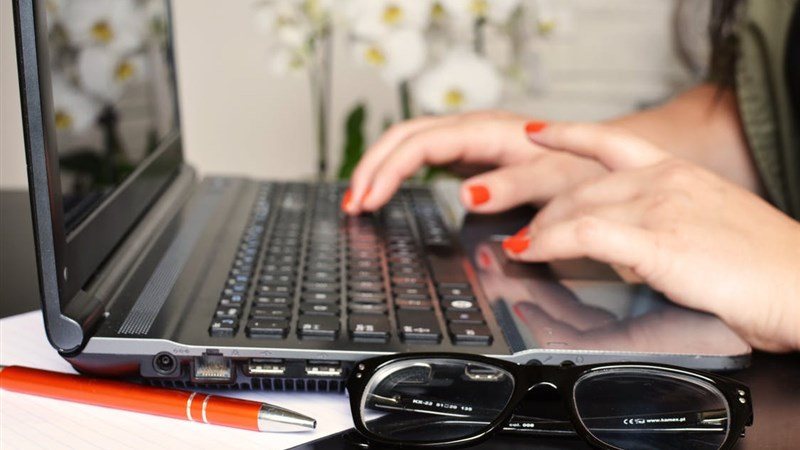 Pen, Spectacle, and Laptop on Workdesk