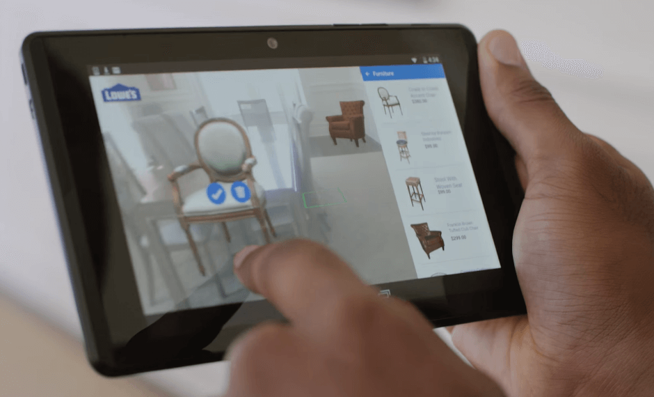 Photo of a person’s hand moving virtual chairs on his tablet